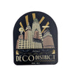 Sticker with a stylized cityscape and 'Deco District' text on a white background
