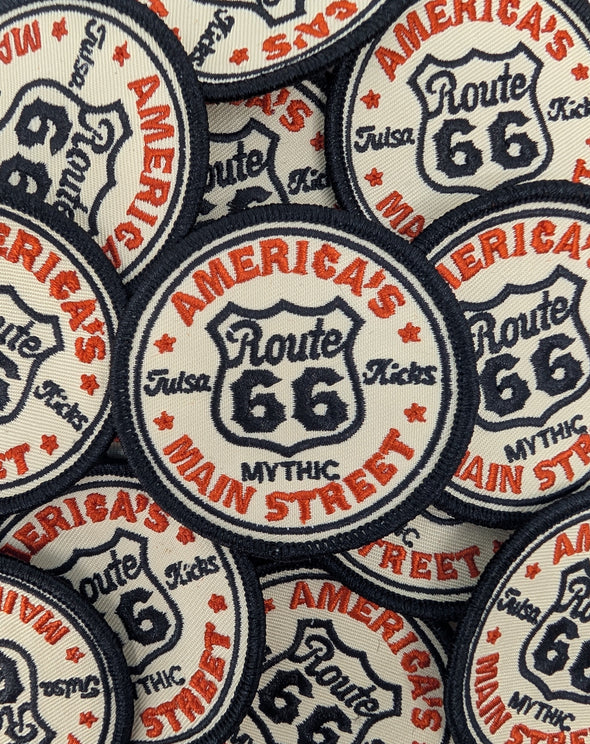 Collection of Route 66 patches with text and logo.